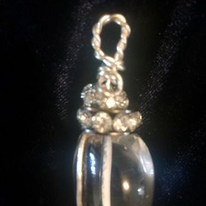 Clear crystal quartz pendant with rhinestones.
